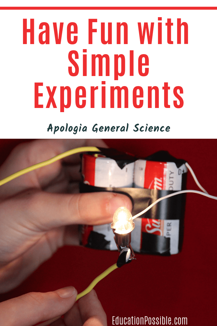A simple circuit science experiment made from D cell batteries, wire, a paper clip, electrical tape and a small light bulb.