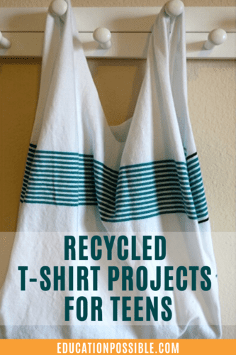 Full image of handmade two handled bag made from a white t-shirt with thin teal stripes on the top just below the handles, hanging on white wooden peg hooks. Teal text overlay on bottom reads Recycled T-Shirt Projects for Teens.