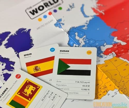The World Game set up with three cards face up on the colorful world map.