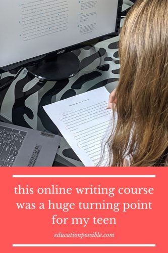 Looking over the back of a teen girl's head. She's holding a red pencil, editing a paper on a glass desk. A computer with editing notes is in the background.