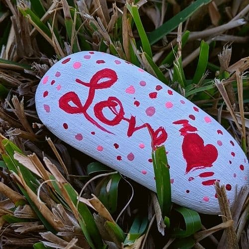 Painted rock with love script and heart