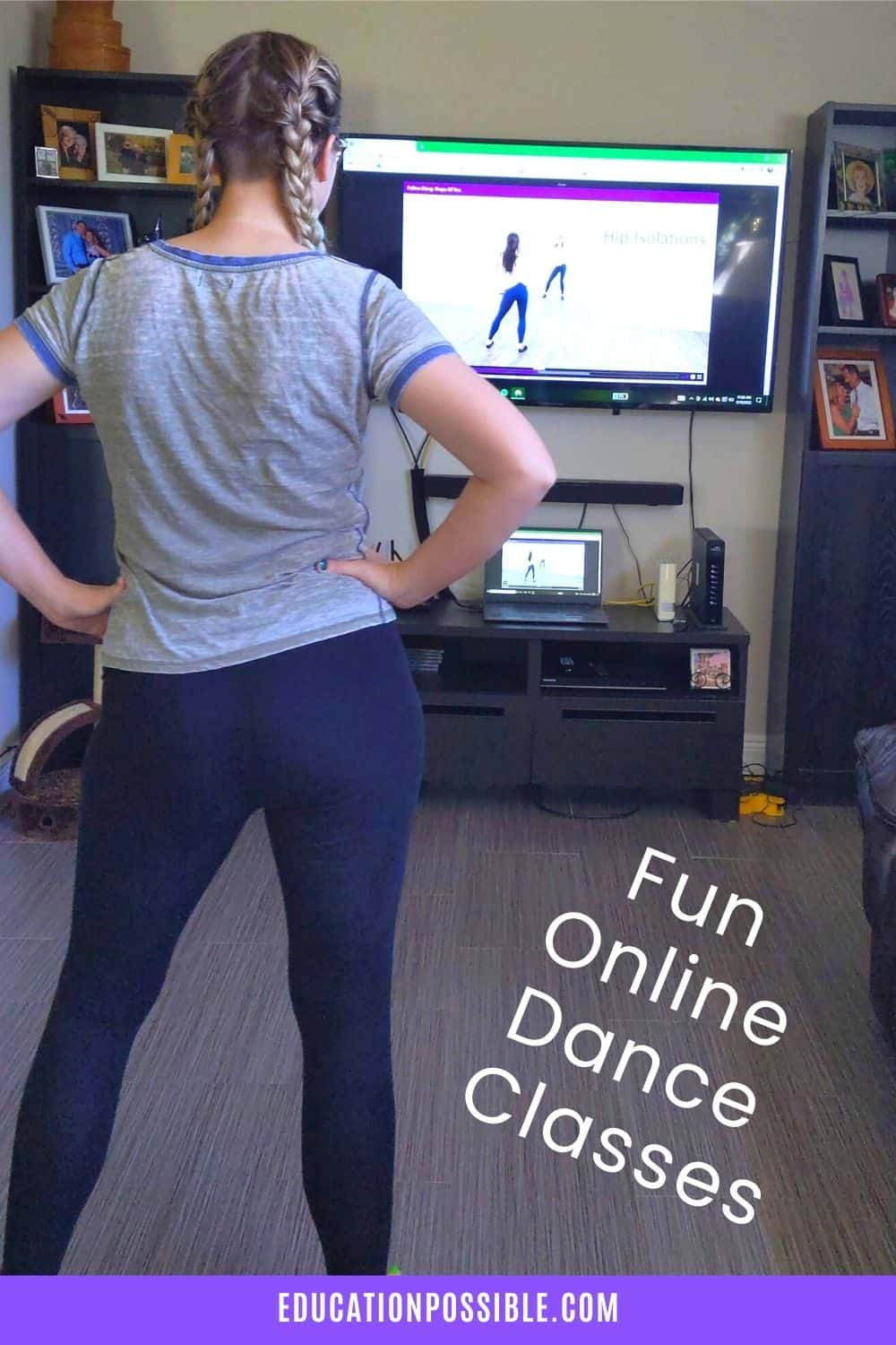 Teen girl dancing in front of a computer hooked up to a TV.