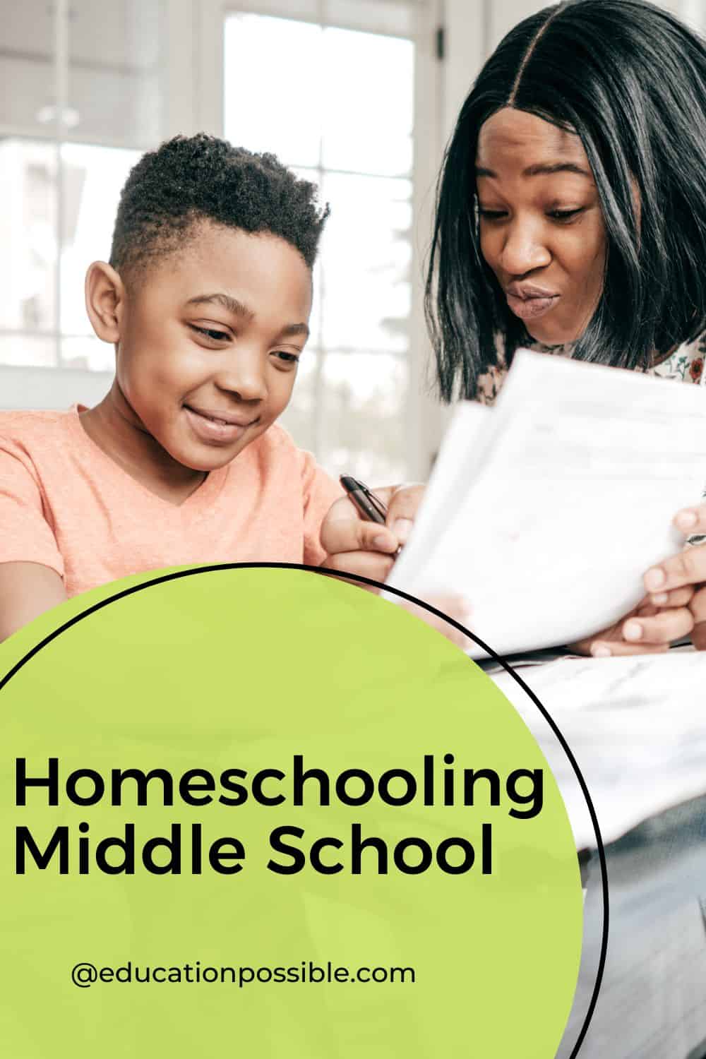 African American mom and tween son going over school papers at dining room table.