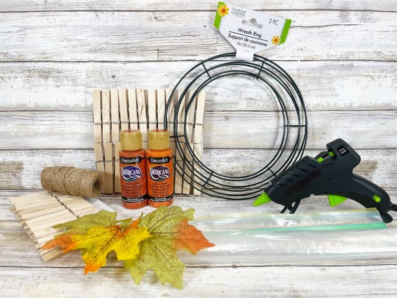 Supplies to make a clothespin pumpkin wreath craft