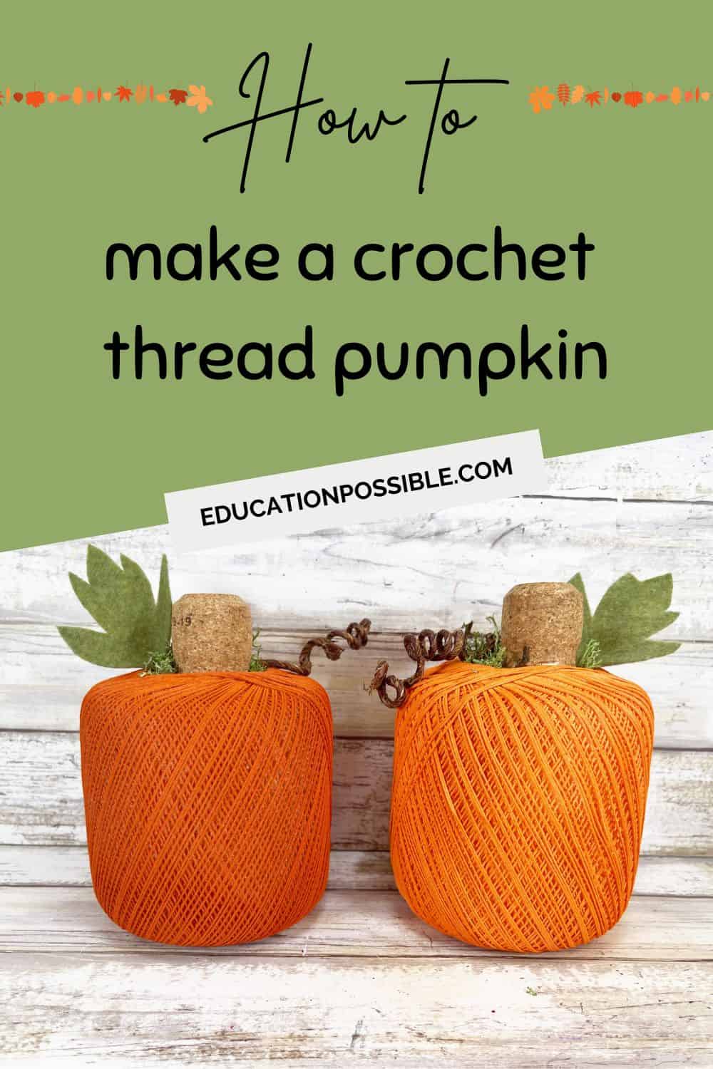Two orange pumpkins made from a ball of crochet thread on a white wooden table.