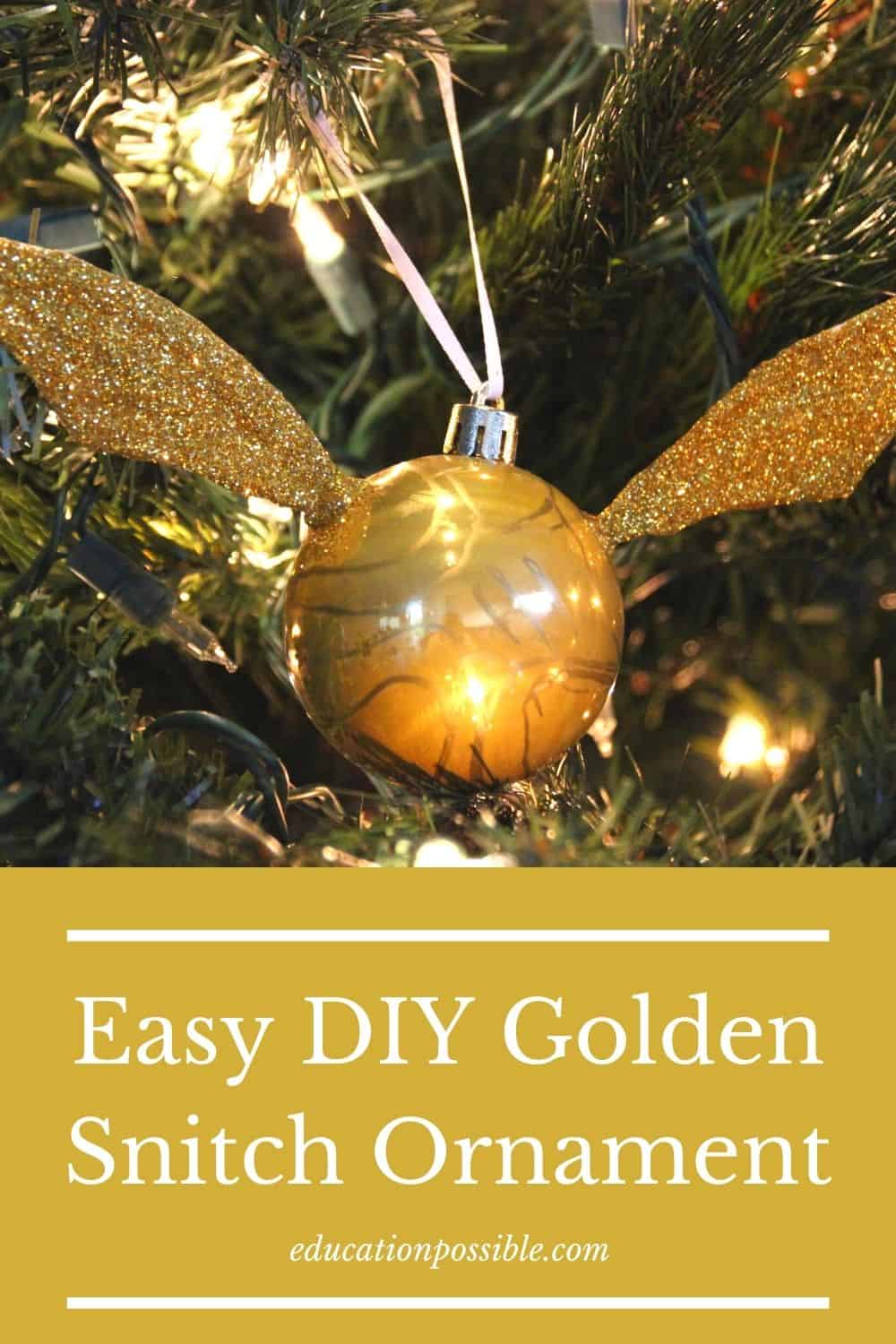 Homemade golden snitch ornament hanging on a Christmas tree.