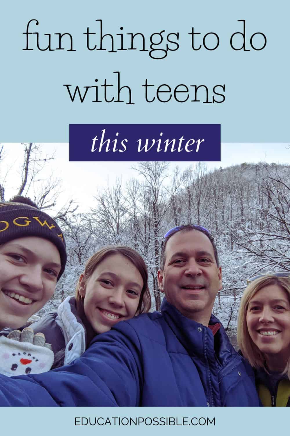 Mom, dad and two teen girls outside with snowy trees and hill behind them