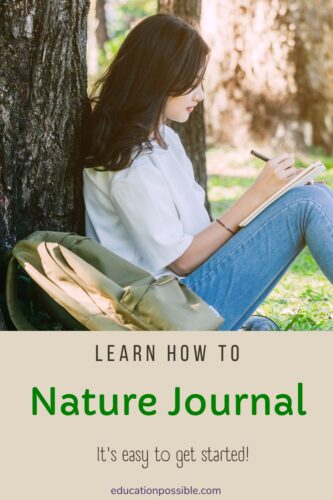 Teen girl is sitting against a large tree in the woods, writing in a notebook. Nature journaling.