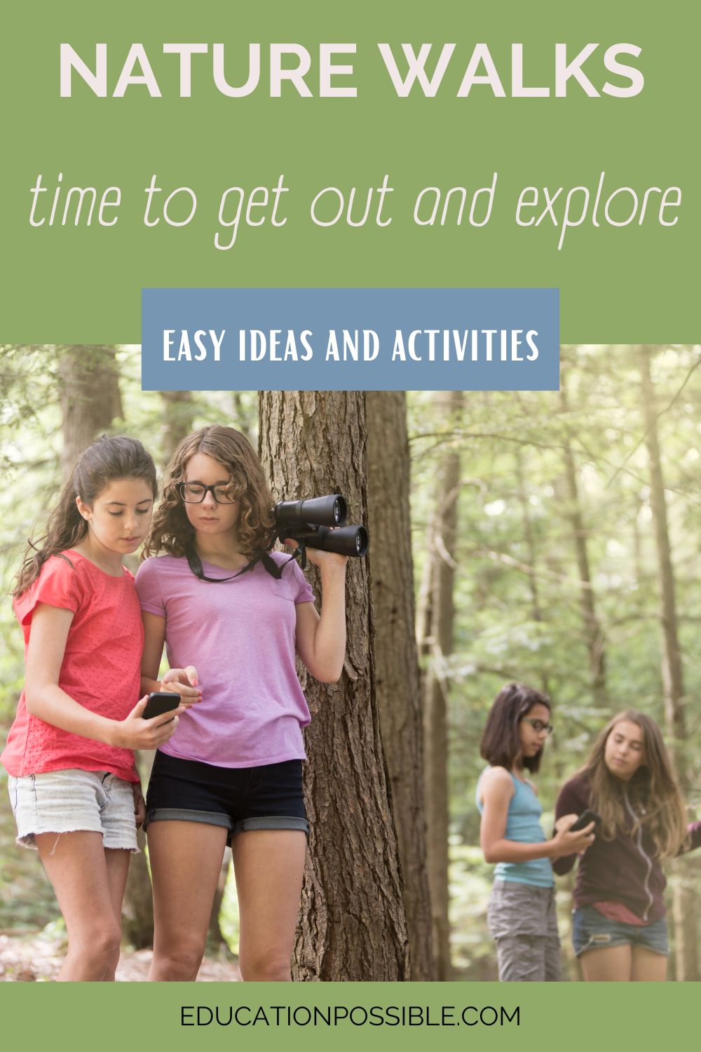 4 tween girls are in 2 pairs standing next to large trees exploring nature, wearing shorts and short sleeves. One of each pair is holding binoculars and the others are holding cell phones.