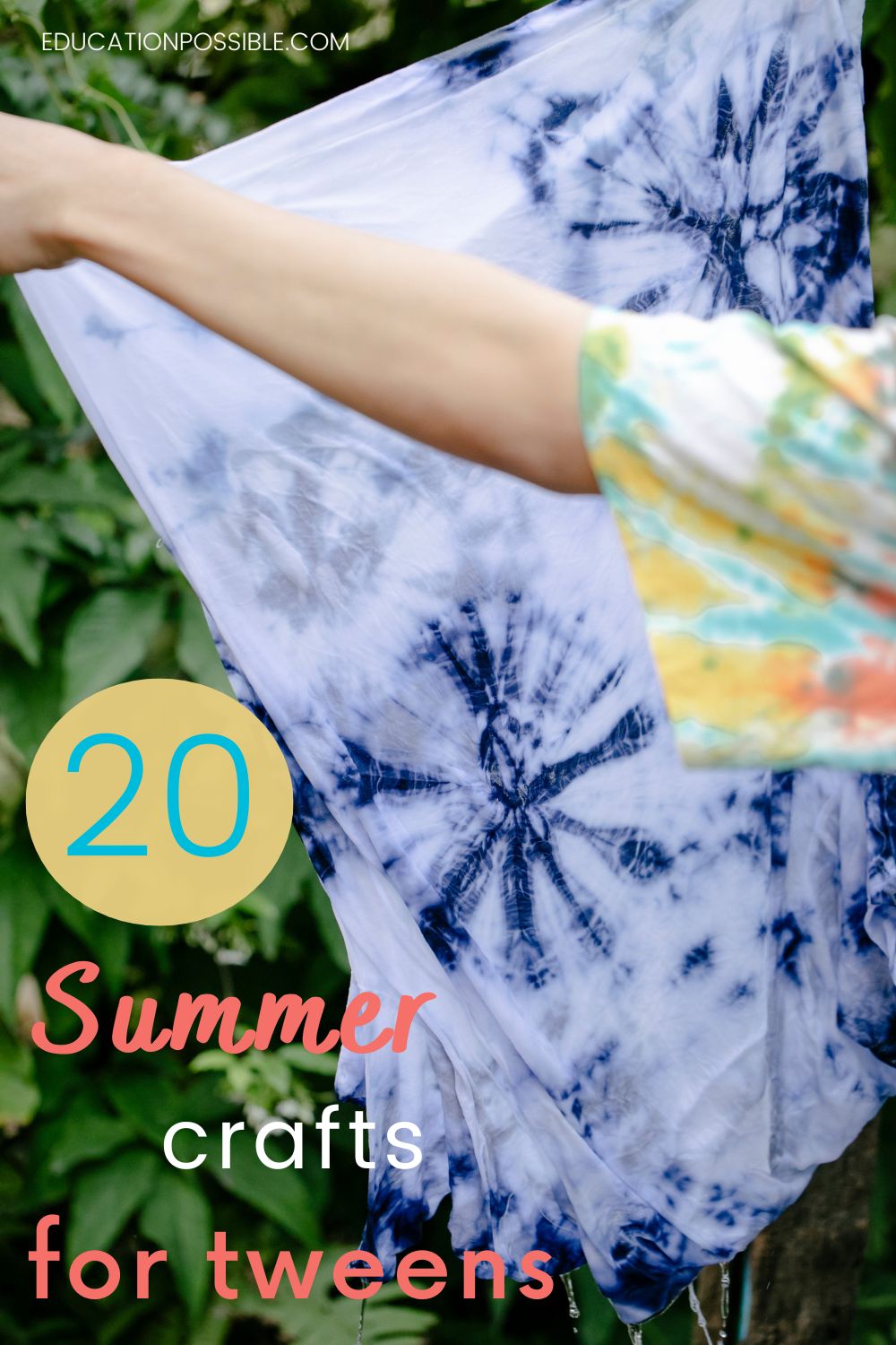 Tween's arm, wearing a blue, yellow, pink tie-dye shirt holding up a blue and white tie-dyed shirt.